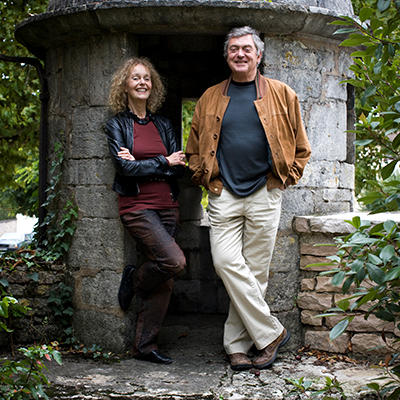 Martha and George Butterfields stand infront of a stone structure