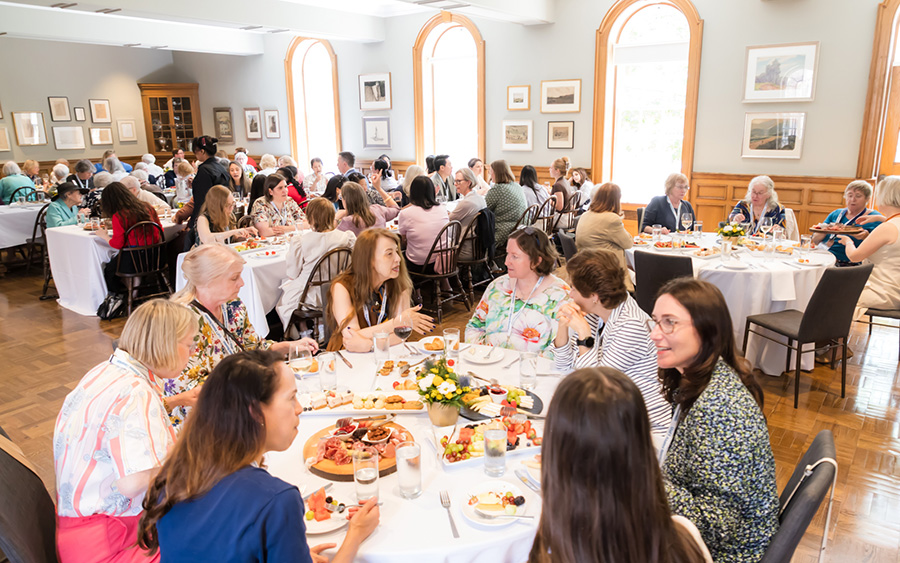 People being served dinner at an event in St. Hilda's College
