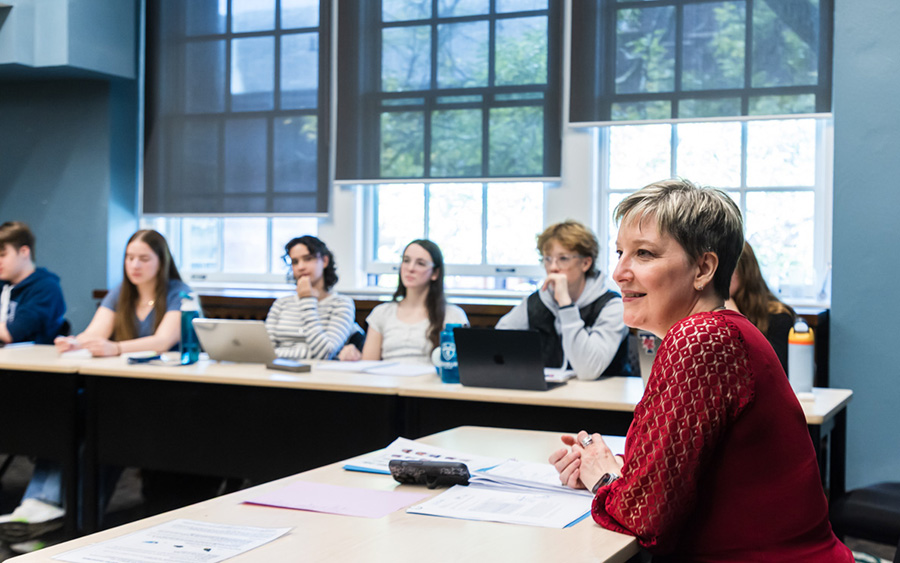 Professor listening to students in a seminar class