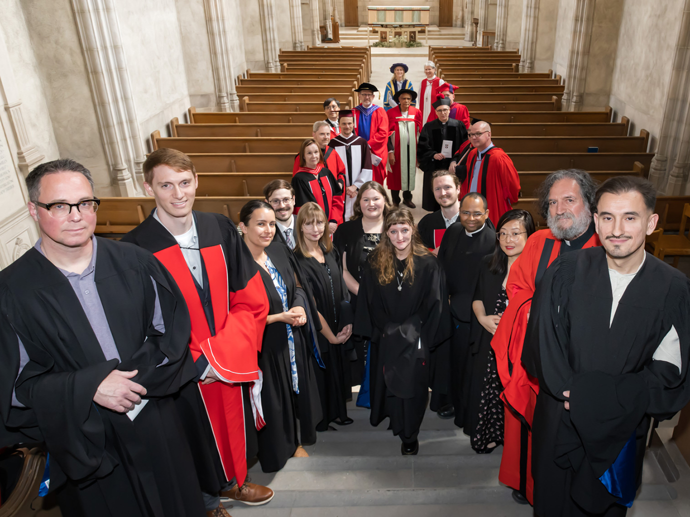 Graduating students at faculty in the Chapel for Caput before Faculty of Divinity Convocation 2026