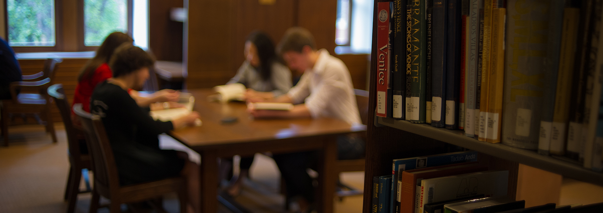 Four students at a table studying in the John W Graham Library