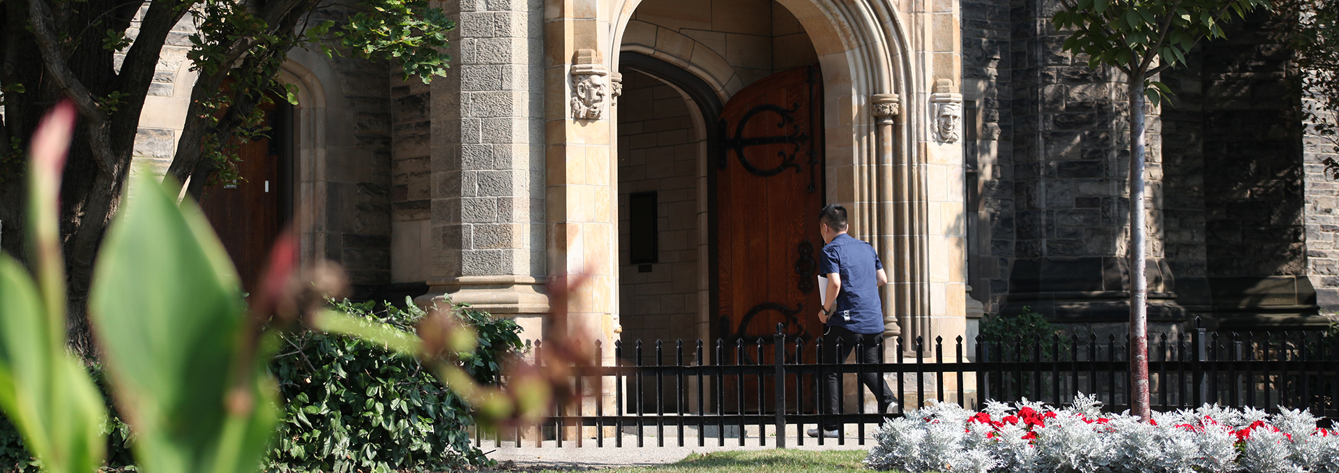 Student walking through front entrance of the main Trinity building