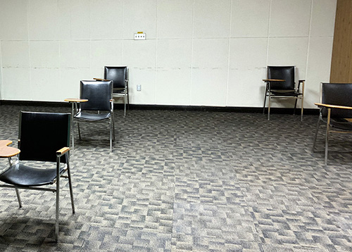 Desks in a classroom set up with physical distancing