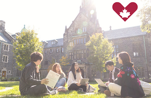 Students sitting on the grass in the Trinity Quad with Giving Tuesday logo