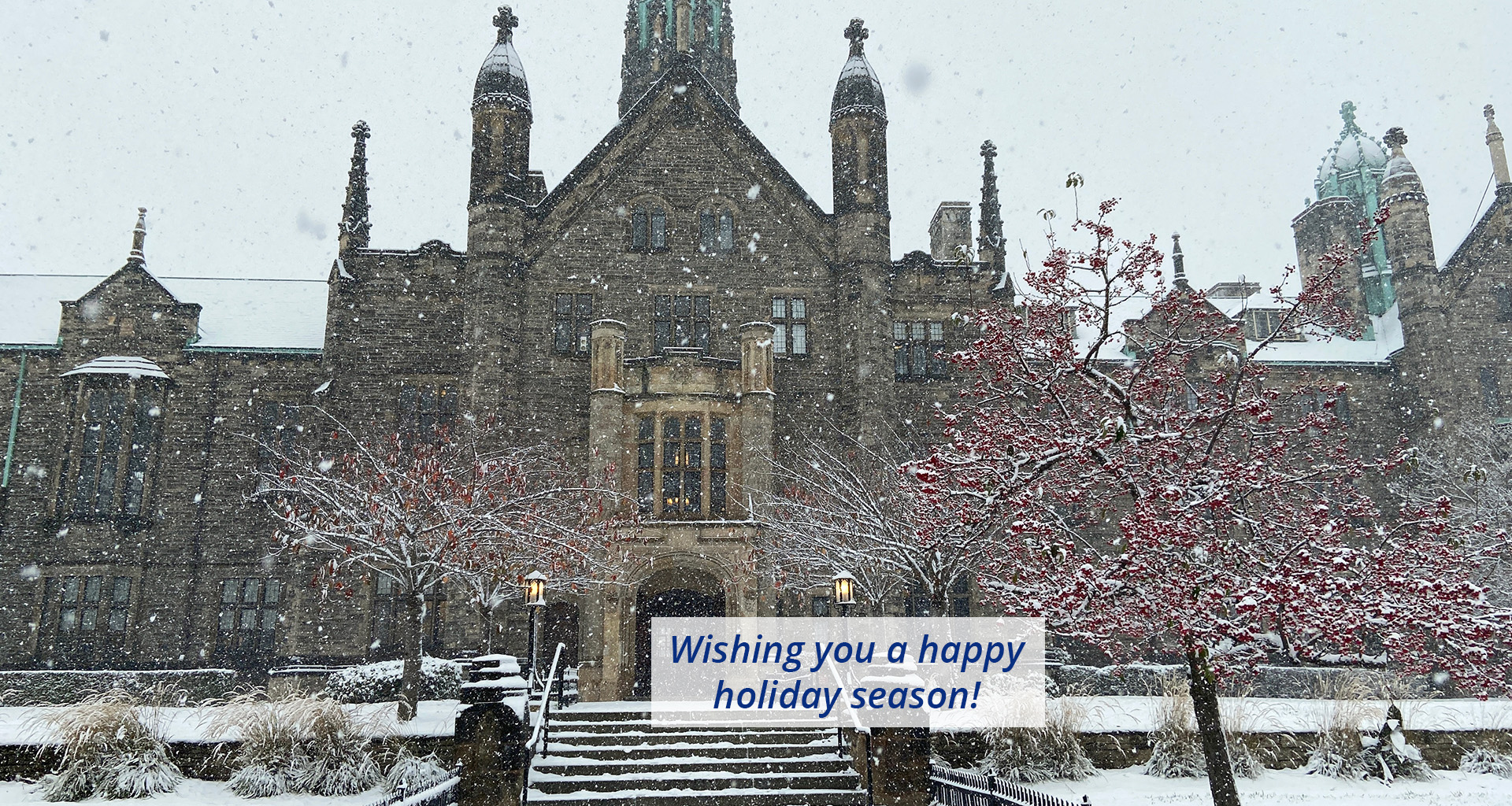 View of Trinity College during a winter snow storm with text: Wishing you a happy holiday season!