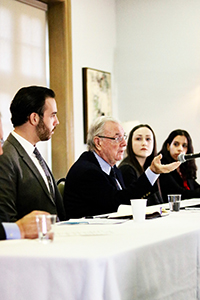 The Hon. Paul Martin with IR Society students sit at the panel table
