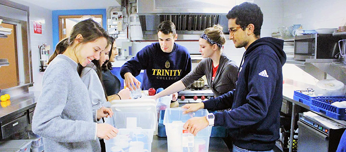 Students packing food items for a Trinity College Volunteer Society (TCVS) event
